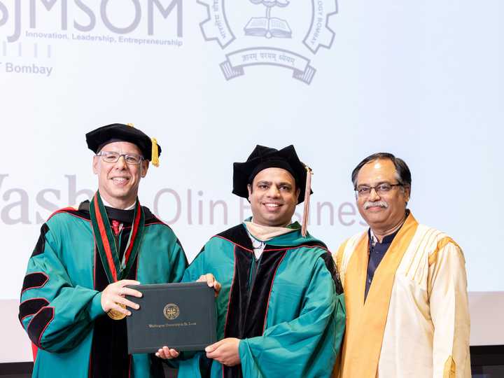 Ankit Dhir receiving his Executive MBA diploma from Washington University in St. Louis' Olin Business School